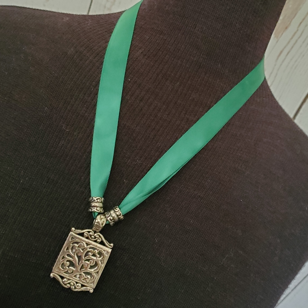 Silvertone filigree pendant necklace on a deep emerald green ribbon "chain"